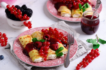 Crepes with lemon cream and raspberry jam. .selective focus.