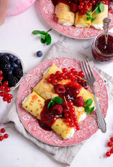 Crepes with lemon cream and raspberry jam. .selective focus.