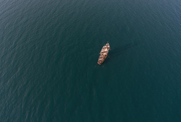 Retro sailing ship in open sea. Aerial top view