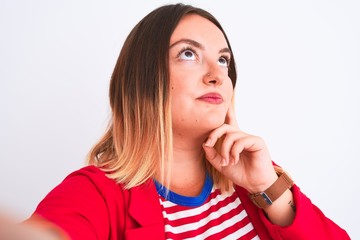 Beautiful woman wearing striped t-shirt and jacket standing over isolated white background serious...
