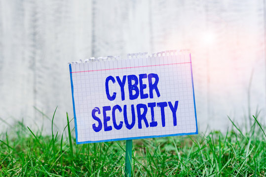 Word writing text Cyber Security. Business photo showcasing protection of internetconnected systems from cyberattacks Mathematic paper attached to a stick and placed in the green grassy land