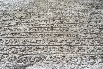 Sinhalese language stone book on wall of 12th century stone Hindu structure. Polonnaruwa, Sri Lanka. UNESCO World heritage Site.