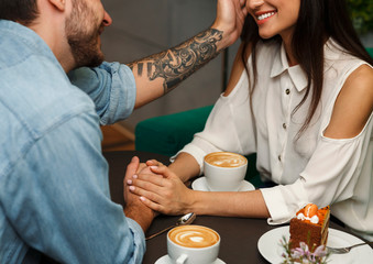Boyfriend Touching Girlfriend's Hair Having Romantic Date In Cafe, Cropped
