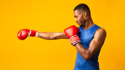 Portrait of confident black man wearing red gloves