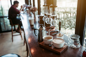 Cappuccino coffee and hot tea in the cafe