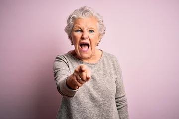 Fotobehang Senior beautiful woman wearing casual t-shirt standing over isolated pink background pointing displeased and frustrated to the camera, angry and furious with you © Krakenimages.com