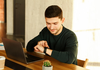 Office Worker At Laptop Checking Time Sitting In Office