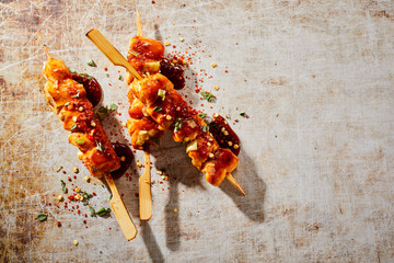 Trio of spicy barbecued chicken breast kebabs