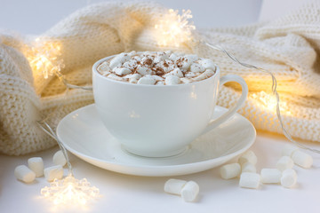Christmas or New Year background with white cup of hot cocoa with marshmallows.