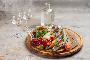 traditional vodka appetizer with herring and beef tongue