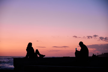 Fototapeta na wymiar Couple on sunset sky background