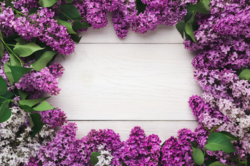 Lilac flowers frame, spring background with heart shape, copy space top view