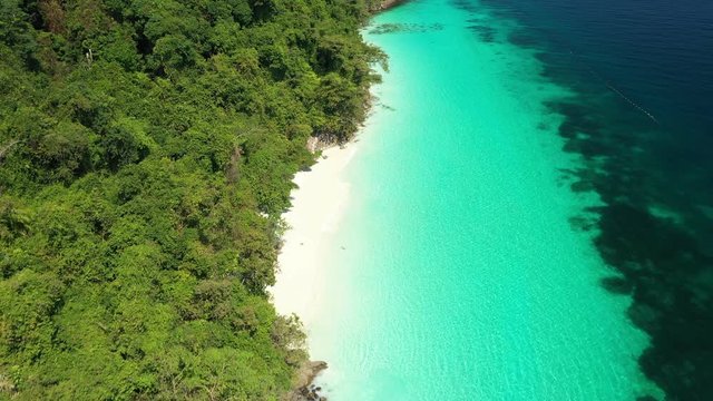 Aerial view of ocean waves, Beautiful tropical beach and rocky coastline and beautiful forest. Nyaung Oo Phee Island Myanmar