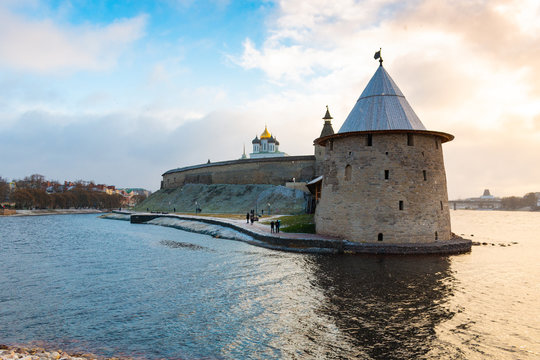 One of the main sightseeing in Pskov city - Ploskaya tower of Pskov Kremlin (also Pskov Krom) and the promenade of Pskova river and Velikaya river. Troitsky church and Kremlin walls on the background