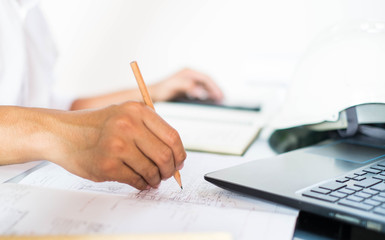 Structural design engineers work in building structure analysis.Closeup video Insturments and office for designer.drawings and computer on the table.Heavy industry business Concept Construction