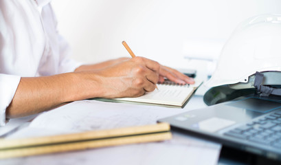 Structural design engineers work in building structure analysis.Closeup video Insturments and office for designer.drawings and computer on the table.Heavy industry business Concept Construction