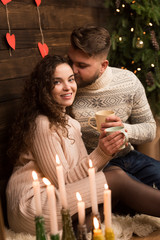 Couple drinking tea with candles in new year night