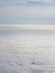 Fototapeta na wymiar Blue hour above the clouds - View from an airplane during blue hour
