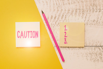Conceptual hand writing showing Caution. Concept meaning Care taken to avoid danger or mistakes...