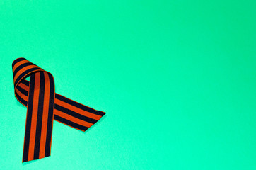 Happy Victory Day! St. George ribbon on a green background. The 75th anniversary of the victory in the Great Patriotic War.