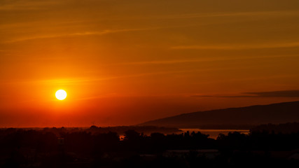 Scenic View Of Silhouette Landscape Against Orange Sky During Sunset