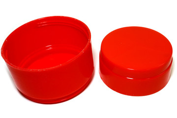 Small red plastic glass placed on a white background