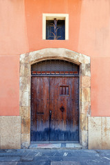 Fototapeta na wymiar Old vintage wood Door in concrete wall.