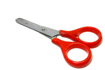 Old small red scissors. The handle is circular, placed on a white background.