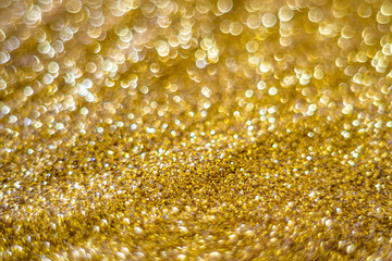 Glitter light abstract gold bokeh blurred background