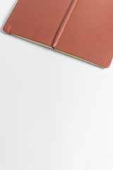 Fototapeta premium Notebook Notepad with a red leather cover on a white background with copy space.