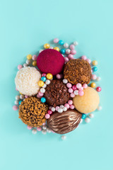 Chocolate candies top view, a composition of festive sweets with sugar beads, candies with different fillings