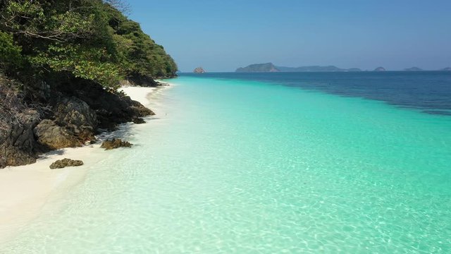 Aerial view of ocean waves, Beautiful tropical beach and rocky coastline and beautiful forest. Nyaung Oo Phee Island Myanmar