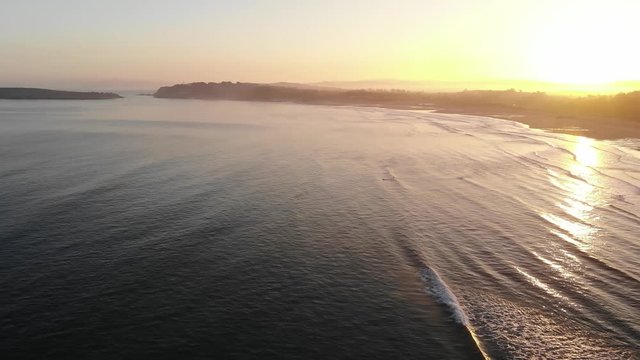 Somo, cantabria at sunrise with mystic views of ocean and mountains