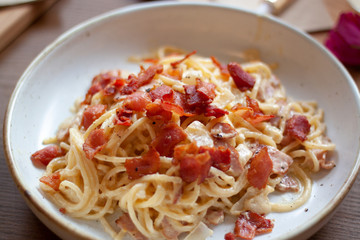 Spaghetti bolognese and spaghetti carbonara, pasta on a white plate Put on a wooden table Concept of western food