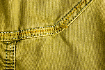 clothing items stonewashed cotton fabric texture with seams, clasps, buttons and rivets, macro