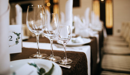 Elegant table setting  with wine glasses and plates. Catering