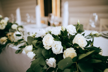 Beautiful table decoration in the restaurant with white roses