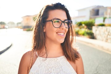 Young beautiful woman on romatic village walking on the town street on a sunny day