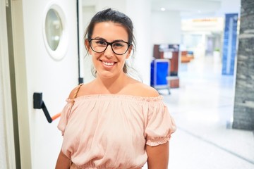 Beautiful girl smiling happy inside of hotel hall