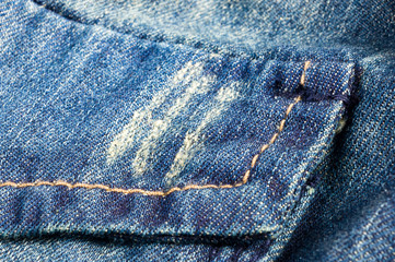 clothing items blue stonewashed faded jeans cotton fabric texture with seams, clasps, buttons and...