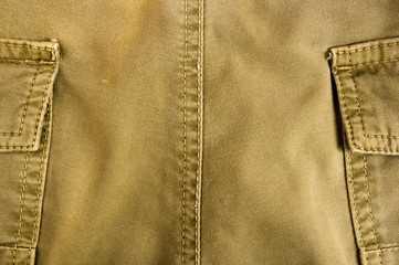 clothing items stonewashed cotton fabric texture with seams, clasps, buttons and rivets, macro