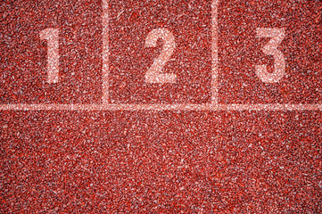 outside red running stadium track with division into tracks and numbers 1, 2 and 3