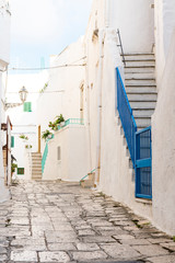 white houses, small alley with stairs in Ostuni, Italy