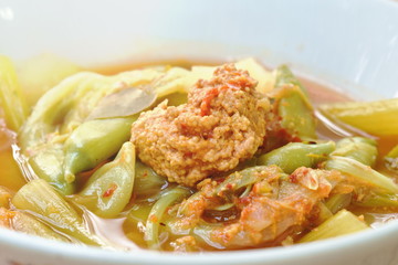 boiled mixed vegetable and fish egg in Thai spicy soup on bowl