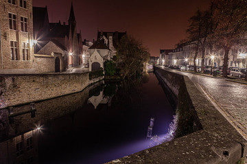 Fototapeta na wymiar Night photos of Bruges. Illumination and reflection in the water Tinted photo and noise application