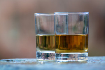 Scotch single malts or blended whisky spirits in glasses with old street in Edinburgh on background, Scotland