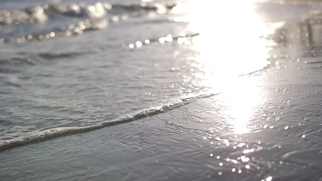 waves on the beach at sunset in Spain, waves with foam slow motion