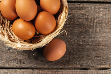 eggs in the hay nest on wooden table