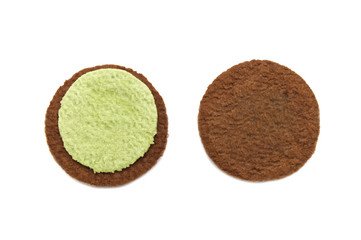 Inside of Chocolate sandwich cookies  filled with matcha green tea flavoured cream close-up isolated on white background.