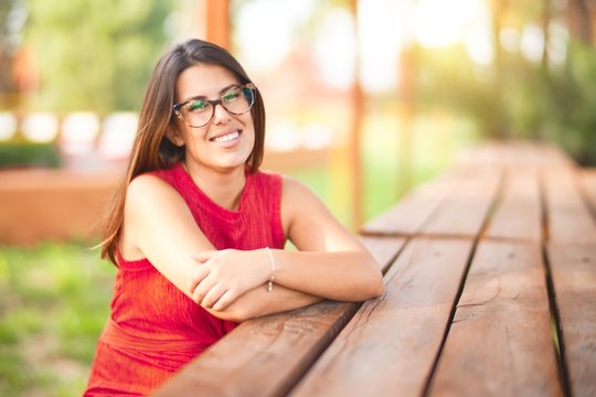 Young beautiful girl smiling happy and confident walking at the town park, standing with a smile on face